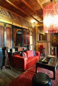 Oriental lounge with wooden lattice walls, red leather couch and black coffee table on rug