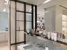 Beauty products on ledge above modern sink
