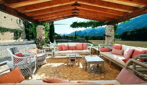 Patio with wicker furniture and pink throw pillows