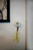 Vintage light switch and slot plastered with mashed potato next to surface-mounted cable