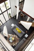 Bird's eye view of a modern living room with black tile floor and floor to ceiling windows