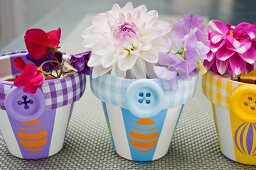 Flowers in plant pots decorated with buttons