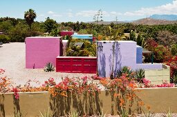 Courtyard of Hotelito with four brightly coloured guest buildings; Rosa, Azul, Verde and Violette