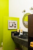 Black stucco sink and countertop in bathroom with lime green walls