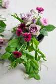 Table decoration made of roses, corn flower and vetches