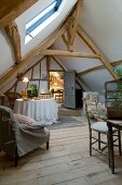 Simple attic room with rustic wooden floor, exposed, old roof beam structure and skylight