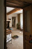 View through open door into interior of restored country house with rustic stone floor in southern France