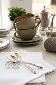 Silver spoons on white, embroidered damask napkins