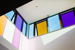View upwards to coloured tilted windows in contemporary building