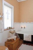 Bathroom with lace border decorating wall and lace-trimmed towels, bathmat & doilies