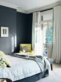 Classic bedroom with pale yellow textile accents combined with dark grey walls