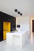 Clarity and elegance in minimalist fitted kitchen with white island counter and black and yellow fronts