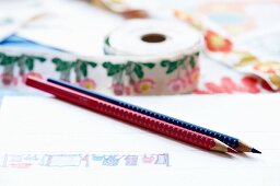 Hand-drawn pattern on white paper with red and blue coloured pencils