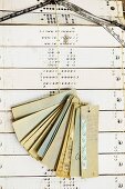 Punched pattern cards and ribbon samples hanging from string