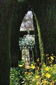 Secretive garden path leading through topiary cypress trees