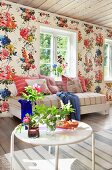 Floral wallpaper in living room of wooden house