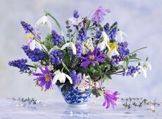 Spring posy of snowdrops, grape hyacinths, anemones and glory of the snow