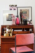 Eclectic vintage decor on bureau combined with 70s chair with velvet upholstery