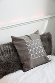 Soft, luxurious guest bed with faux fur and patterned silk scatter cushions