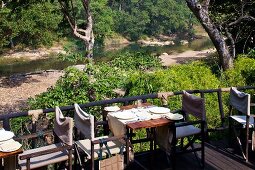 Set table on restaurant terrace with view of river landscape