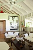 Colonial-style coffee table and rattan sofa set in white wooden cabin