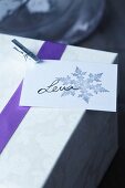 Present tag with stamped snowflake motif and miniature clothes peg