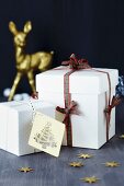 White gift boxes with tartan ribbon and gift tag