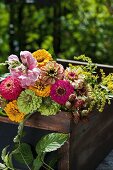 Zinnias and blackberries in colourful bouquet of garden flowers