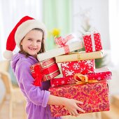 Girl (8-9) carrying christmas gifts