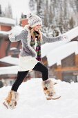 USA, Utah, Salt Lake City, young woman walking through snow in resort