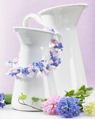 White pitcher decorated with garland of hyacinth florets
