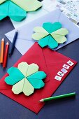 Invitation cards decorated with origami four-leafed clovers