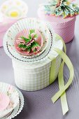 Paper flower made from paper cake cases decorating gift box