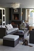 Grey wicker sofa set and coffee table in modern living room with birds'-nest ceiling lamp