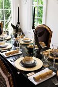 Elegant dining table set for Christmas in black and gold