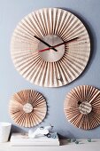 Wall-mounted clock and ornaments made from folded newspaper