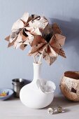 Bouquet of origami newspaper flowers and newspaper dish