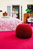 Merino wool pouffe on deep pink carpet in bedroom