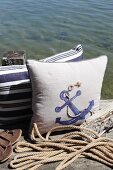 Maritime cushions decorated in classic blue and white with jute yarn and fabric paint