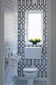 Guest lavatory with black and white graphic pattern on tiles