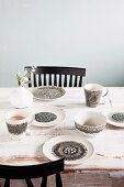 Hand-painted crockery in black and white on vintage table