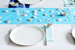 Place setting on table with maritime decorations
