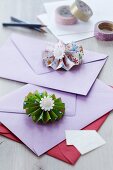 Colourful paper flowers decorating colourful envelopes