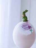 White ostrich egg decorated for Easter with rabbit ornament & pendant