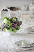 Spring bouquet on table set in white