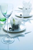 Oriental place settings: rice paper bowls on plates behind stemware glass