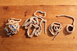 Felting wool and crochet needles on wooden surface