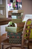 Stack of boxes in retro patterns on wooden Thonet chair