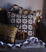 Scatter cushions and Christmas presents draped with paper garlands