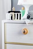 Furniture knob hand-crafted from wooden bead on chest of drawers